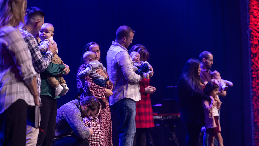 pastor with family on stage