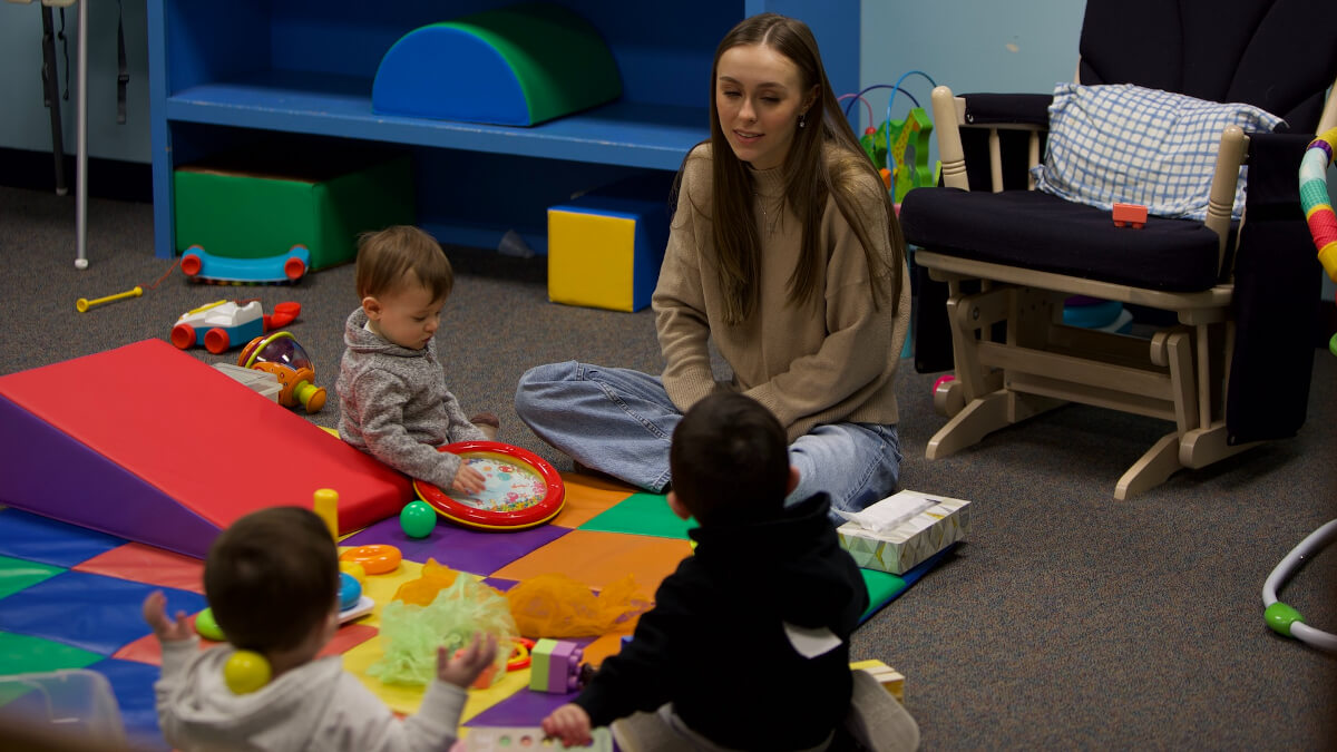girl with children in daycare