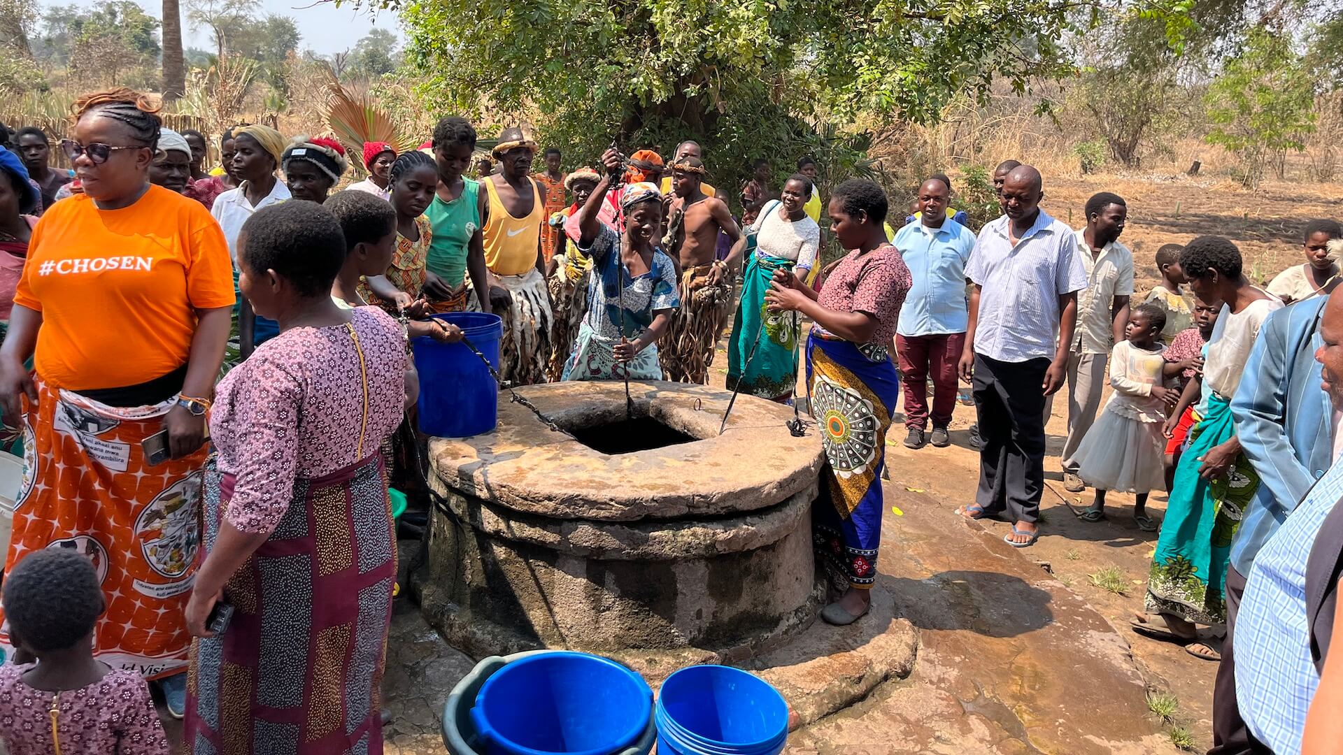 people standing around a well